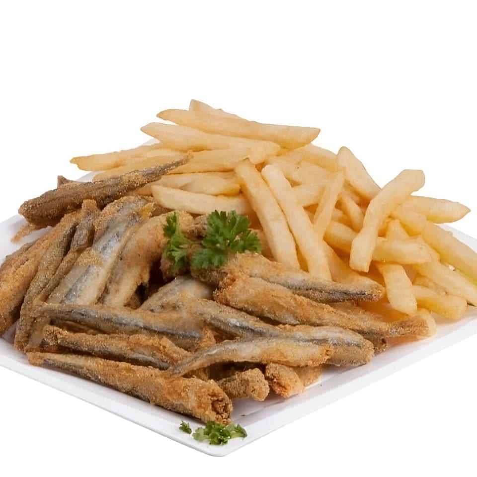 A white plate piled high with golden-brown fried fish and crispy french fries, garnished with parsley.